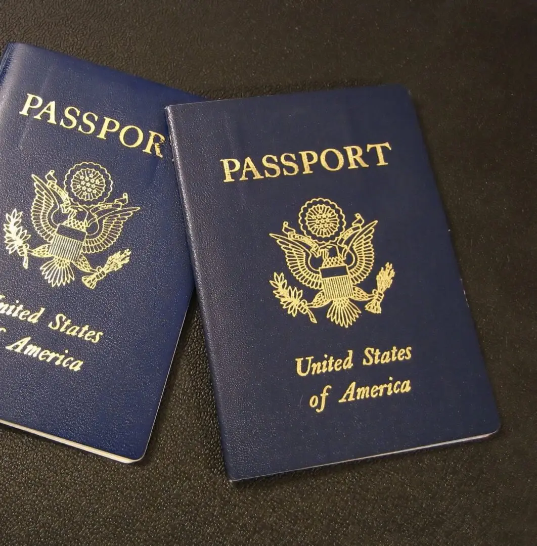 Two passports sitting on top of a table.
